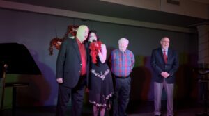 Group of people standing on stage during an event.